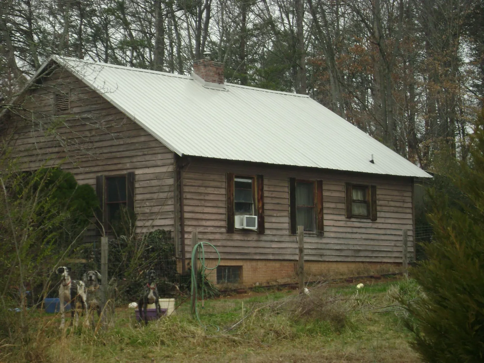 White metal roof on an old wood sided farmhouse, from a Asphalt Shingle Roof Repair job in University Park