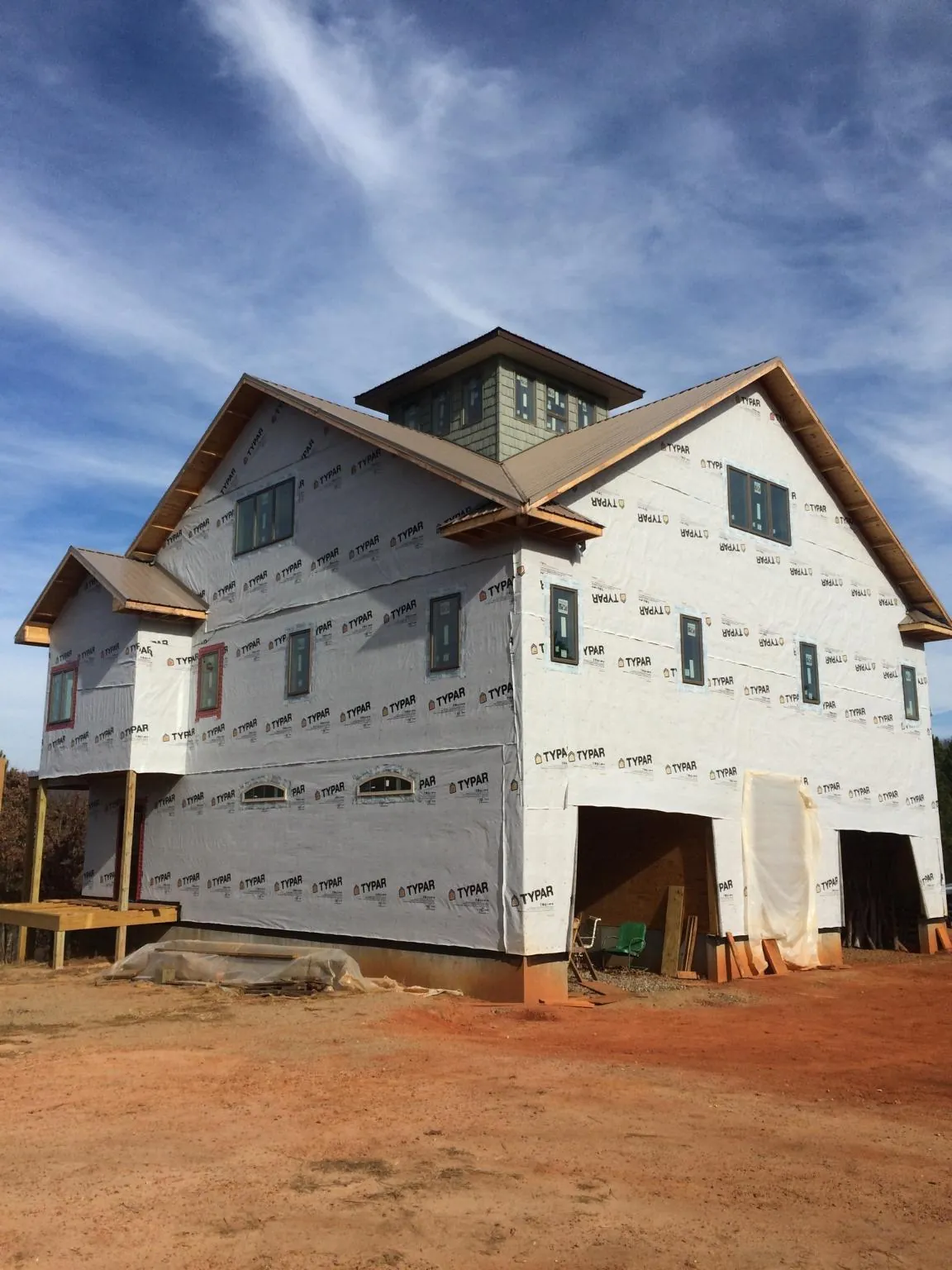 New two story house under construction with a cupola and gabled roofs in University Park